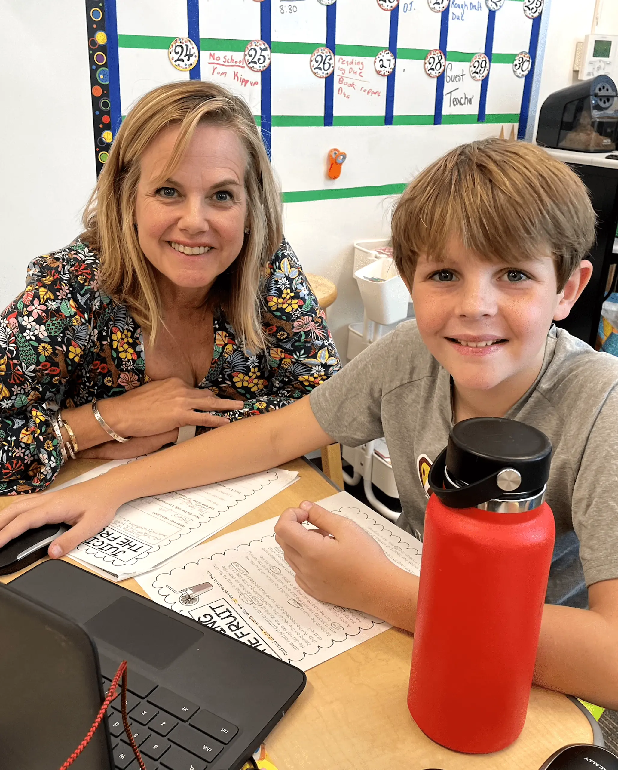 Walker student and teacher smiling at camera