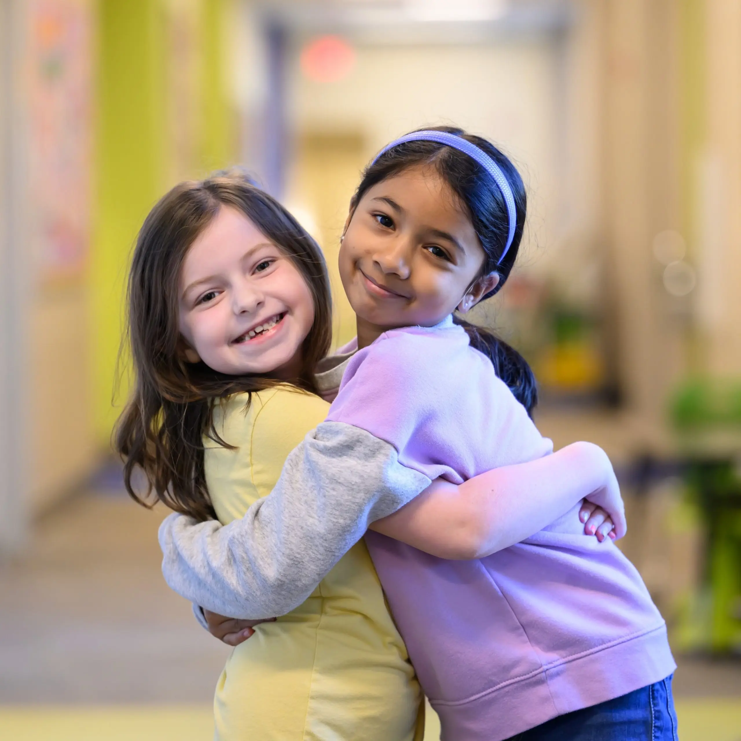 Two girls hugging