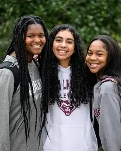 Three students smiling