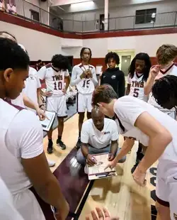 Basketball coach instructing team