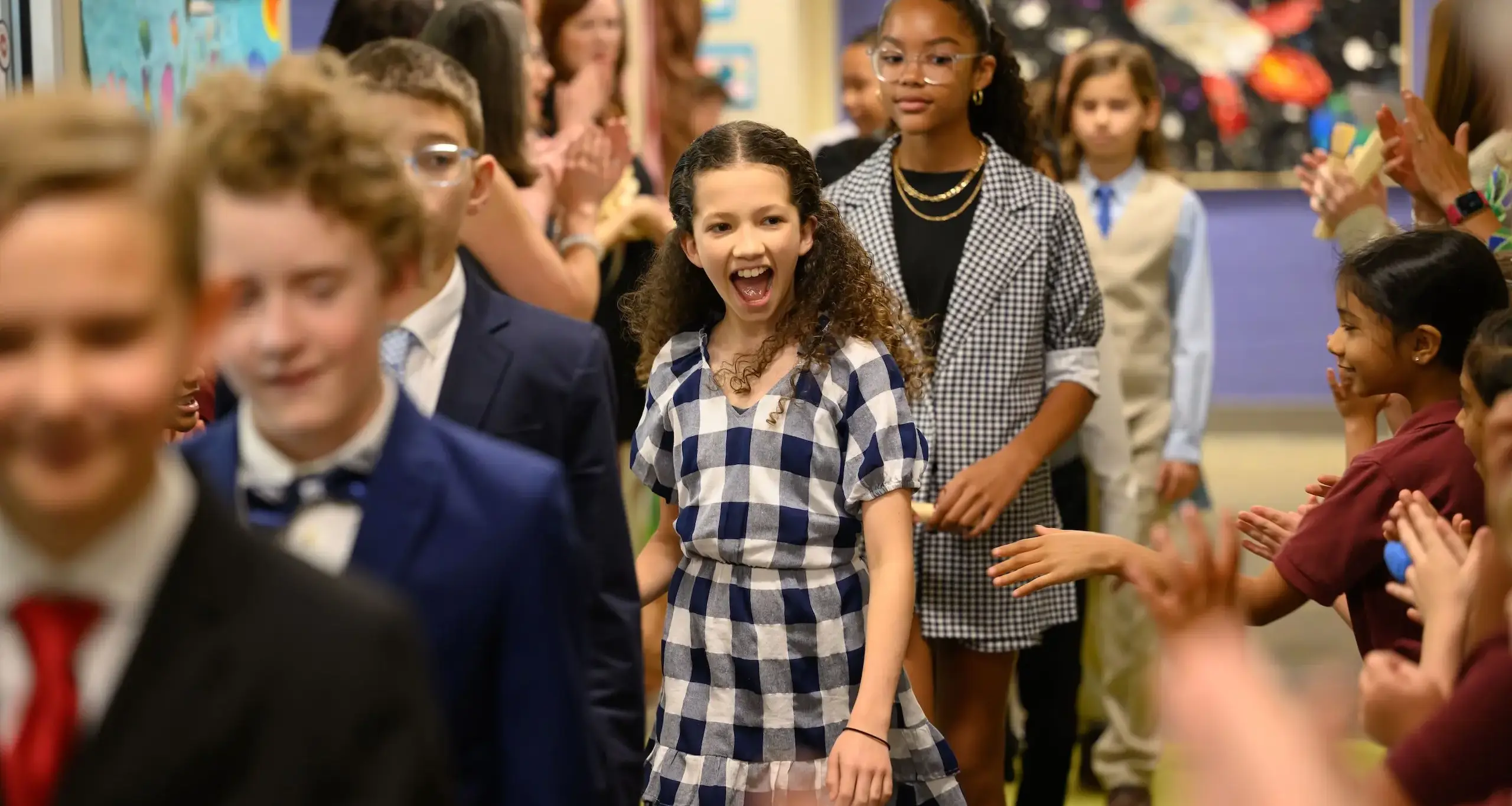 Walker fifth grade giving ceremony with students walking in line smiling