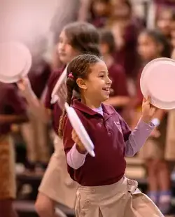 Student with paper plates