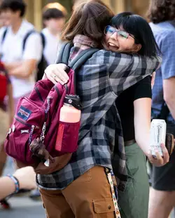 Two students hugging