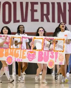 Girls holding a paper bus