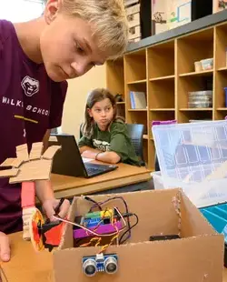 Student looking in boxes