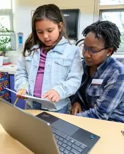 Student showing teacher their work