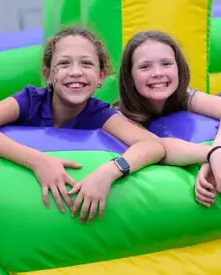 Two girls on a bouncy castle