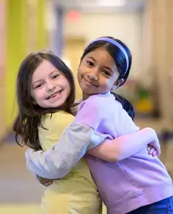 Two girls hugging