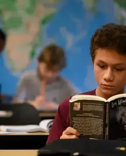 Student reading an abridged copy of Les Mis