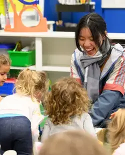 Senior buddy playing with younger students