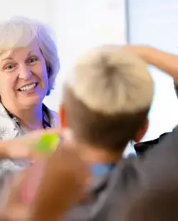 Teacher smiling at student