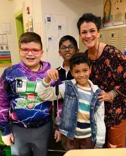 Students and teacher showing off medal