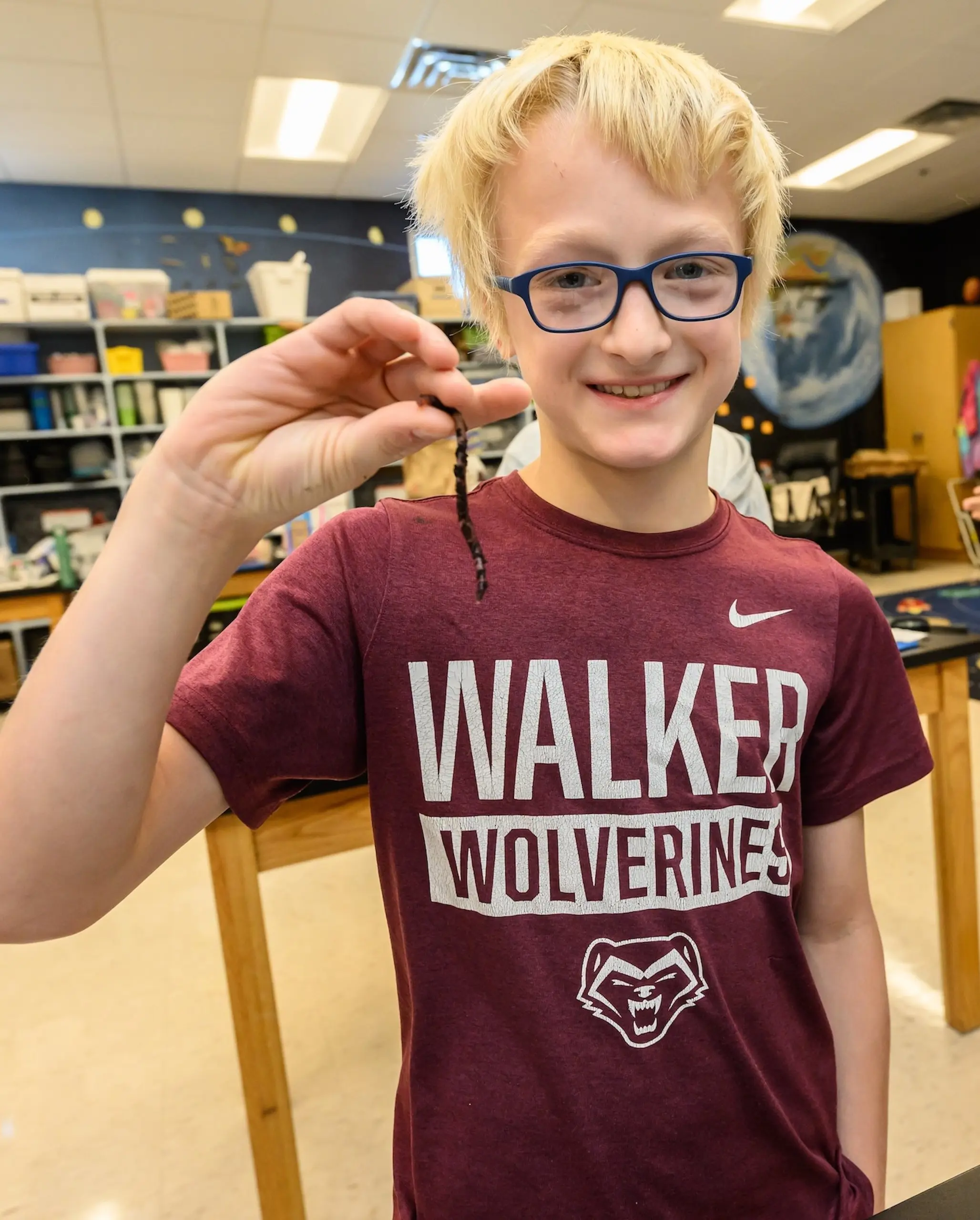 Walker student holding an animal and smiling at camera