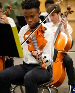 Students playing strings instruments