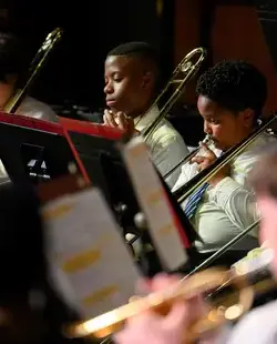 Students playing instruments onstage