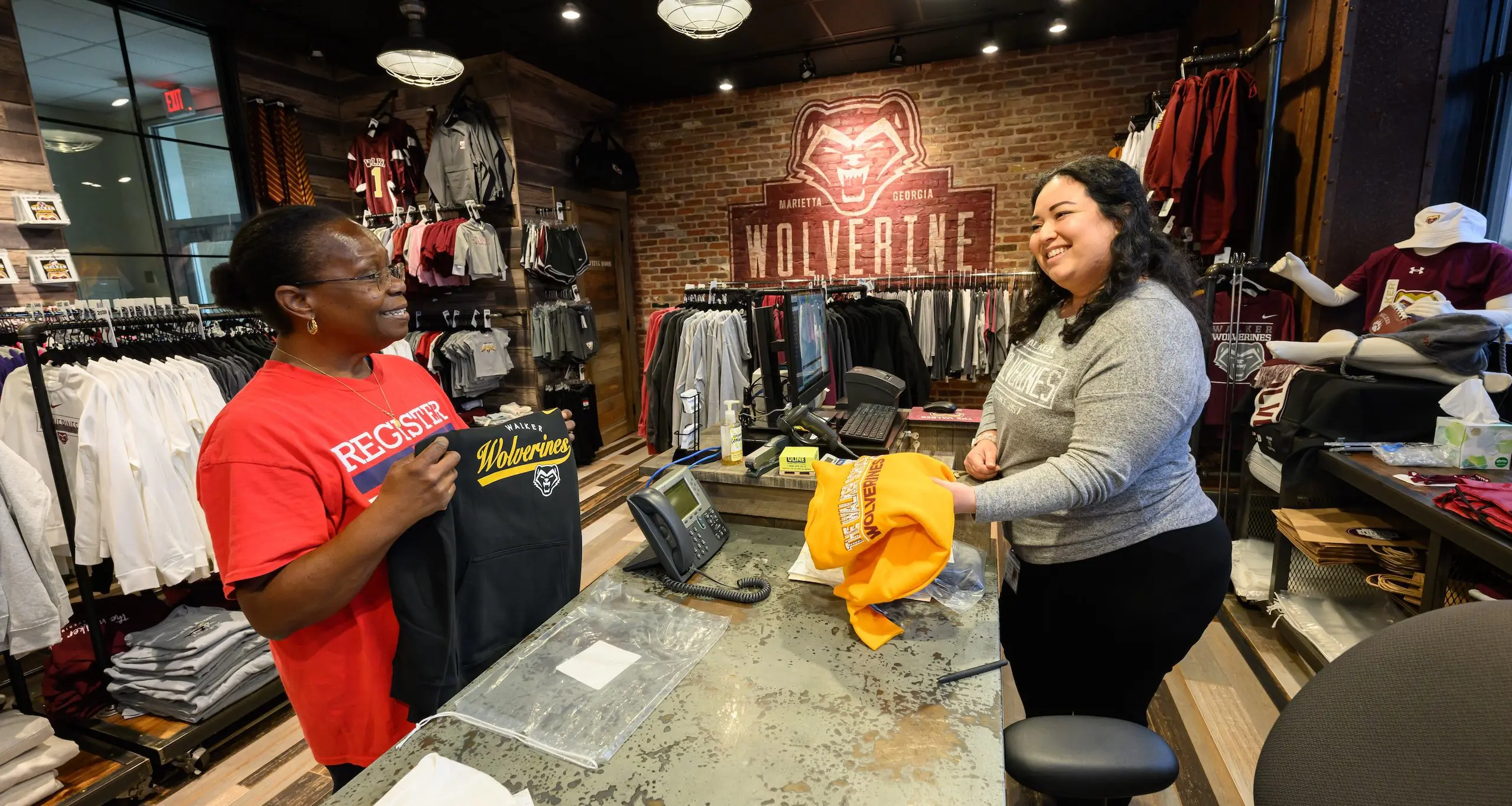 Two wolverine warehouse staff in store